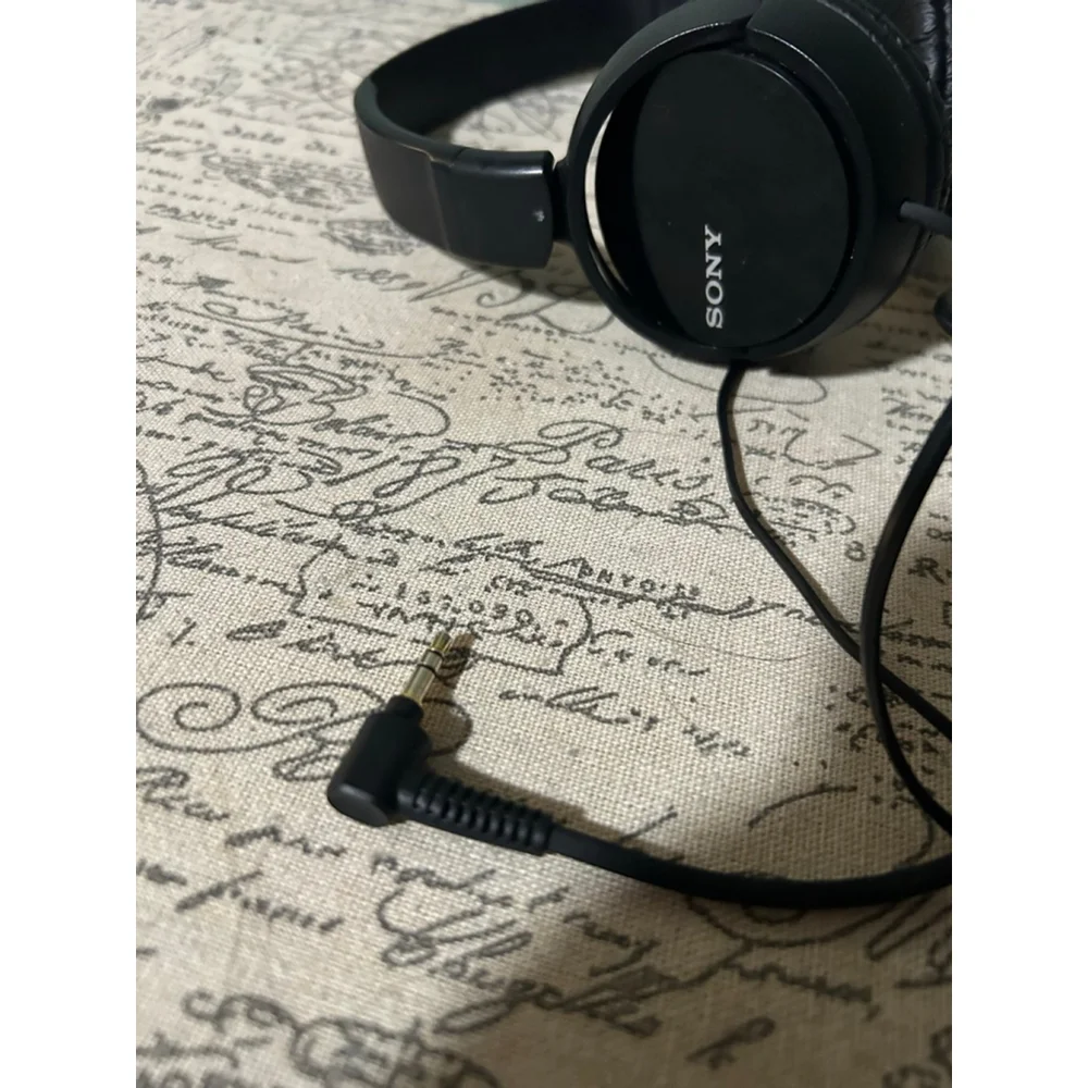 These are a pair of black Sony on-ear wired headphones. The earcups feature the